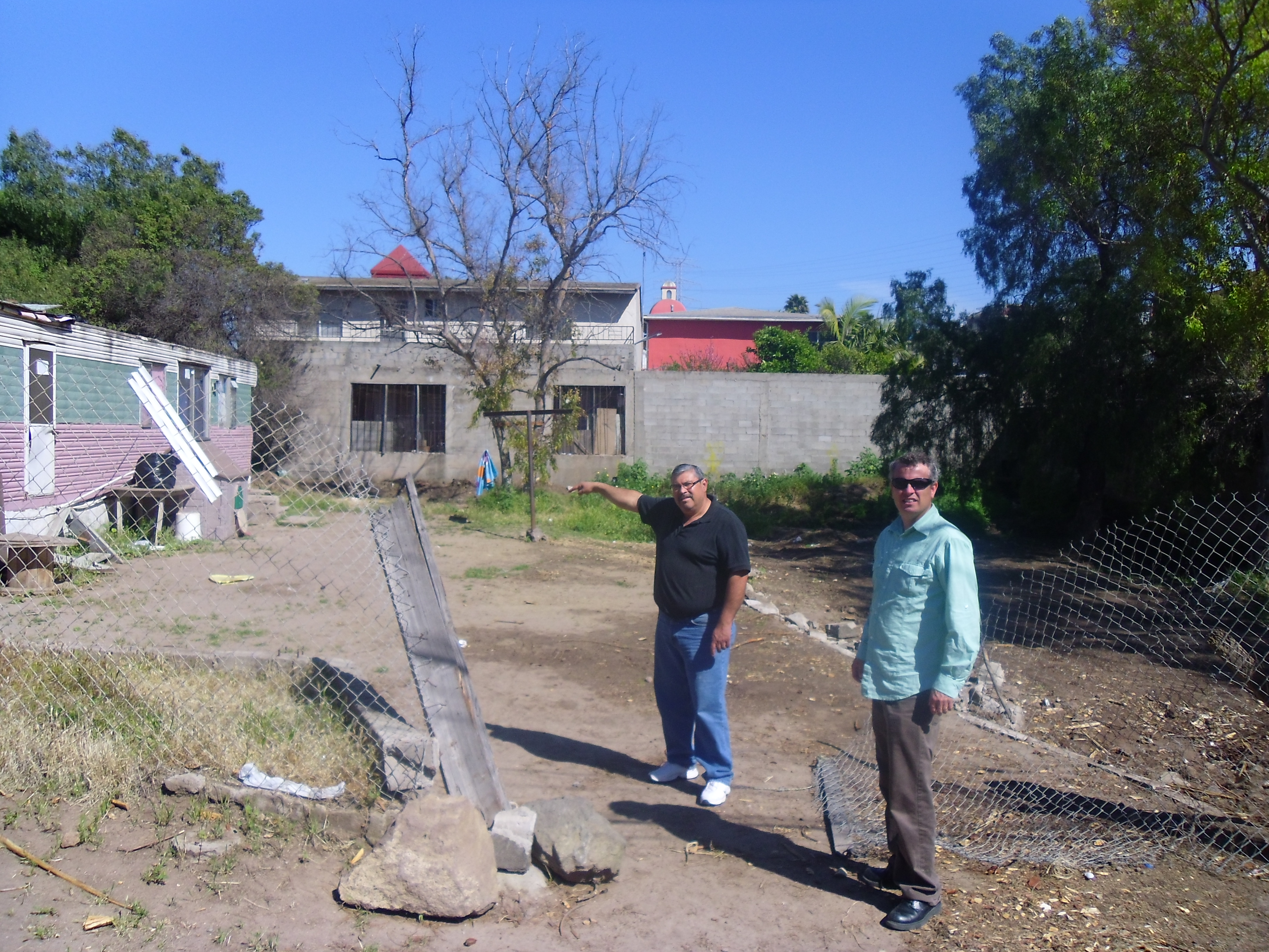 Ray & Daniel on the land where the church will be built with Harbor