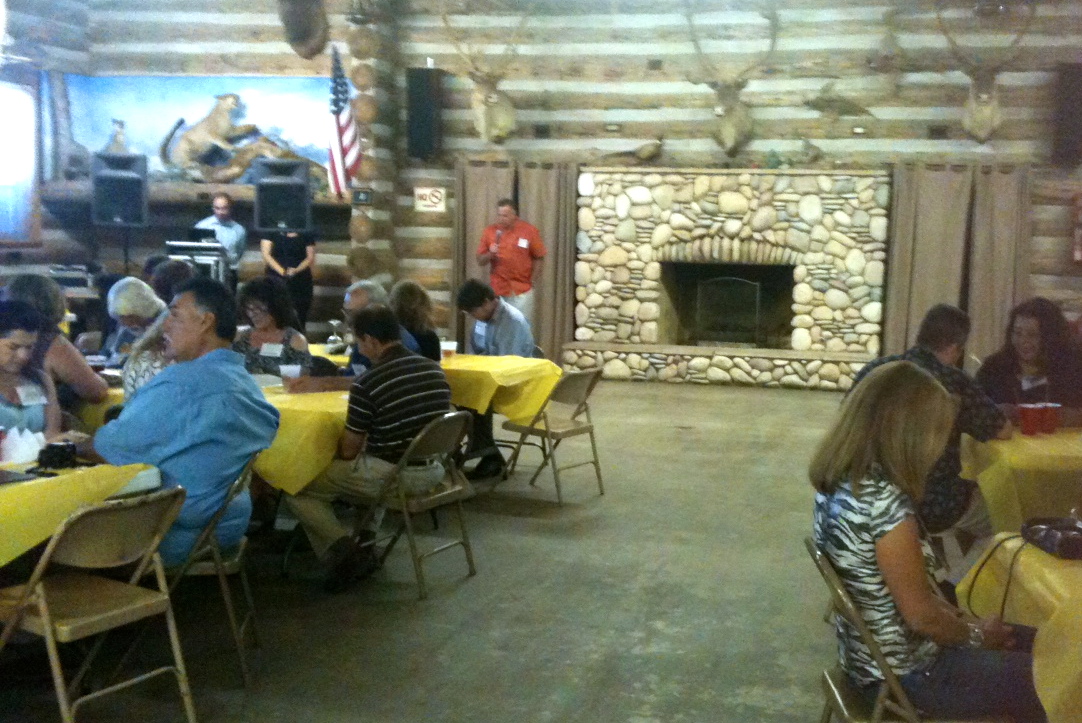 Dave leading friends at reunion in prayer before the dinner