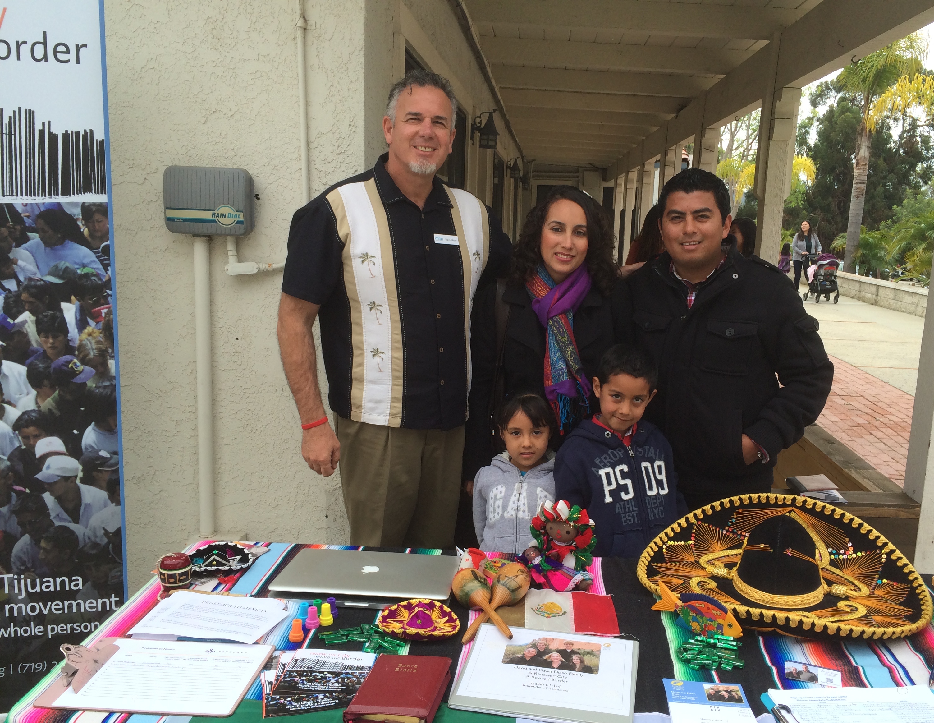 Dave at our missions table with Pastor Abraham and his wife Martha and their two children