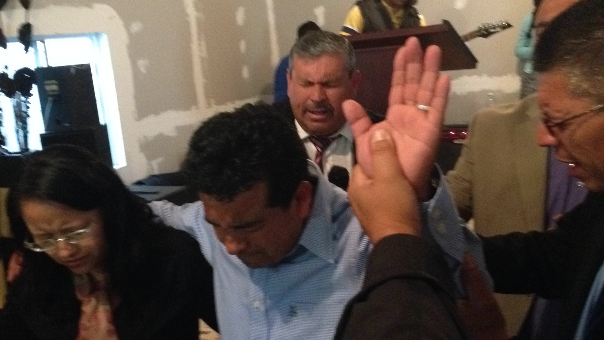 Pastor Daniel praying for Ivan & Rocio during the dedication service