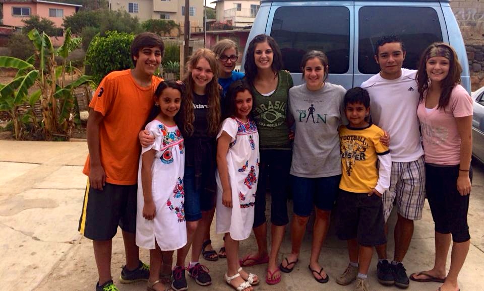 The youth at the van with some of their young friends  that they made during the week
