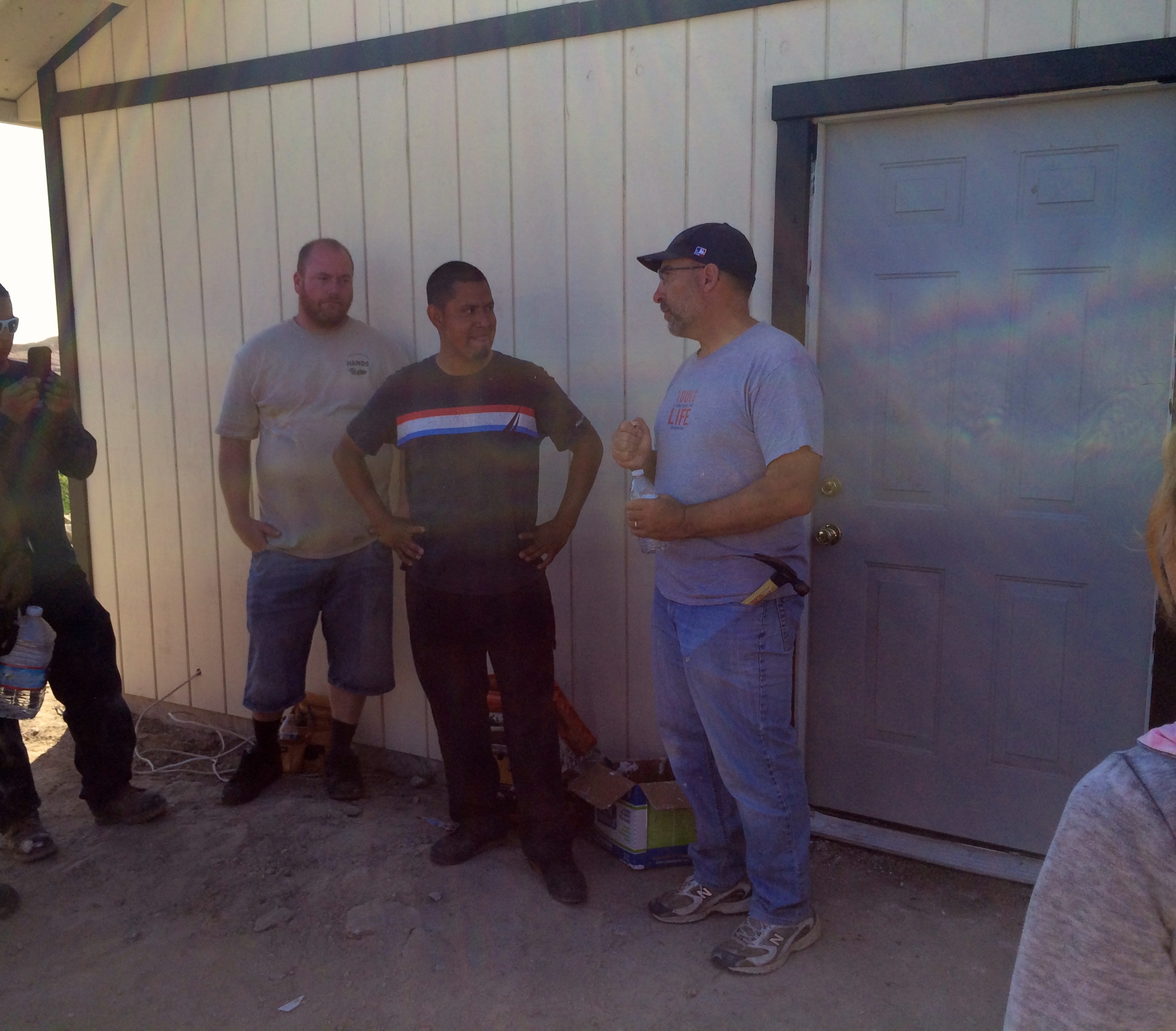 Pastor Bob Klein (on the right) giving the charge to Pastor Victor