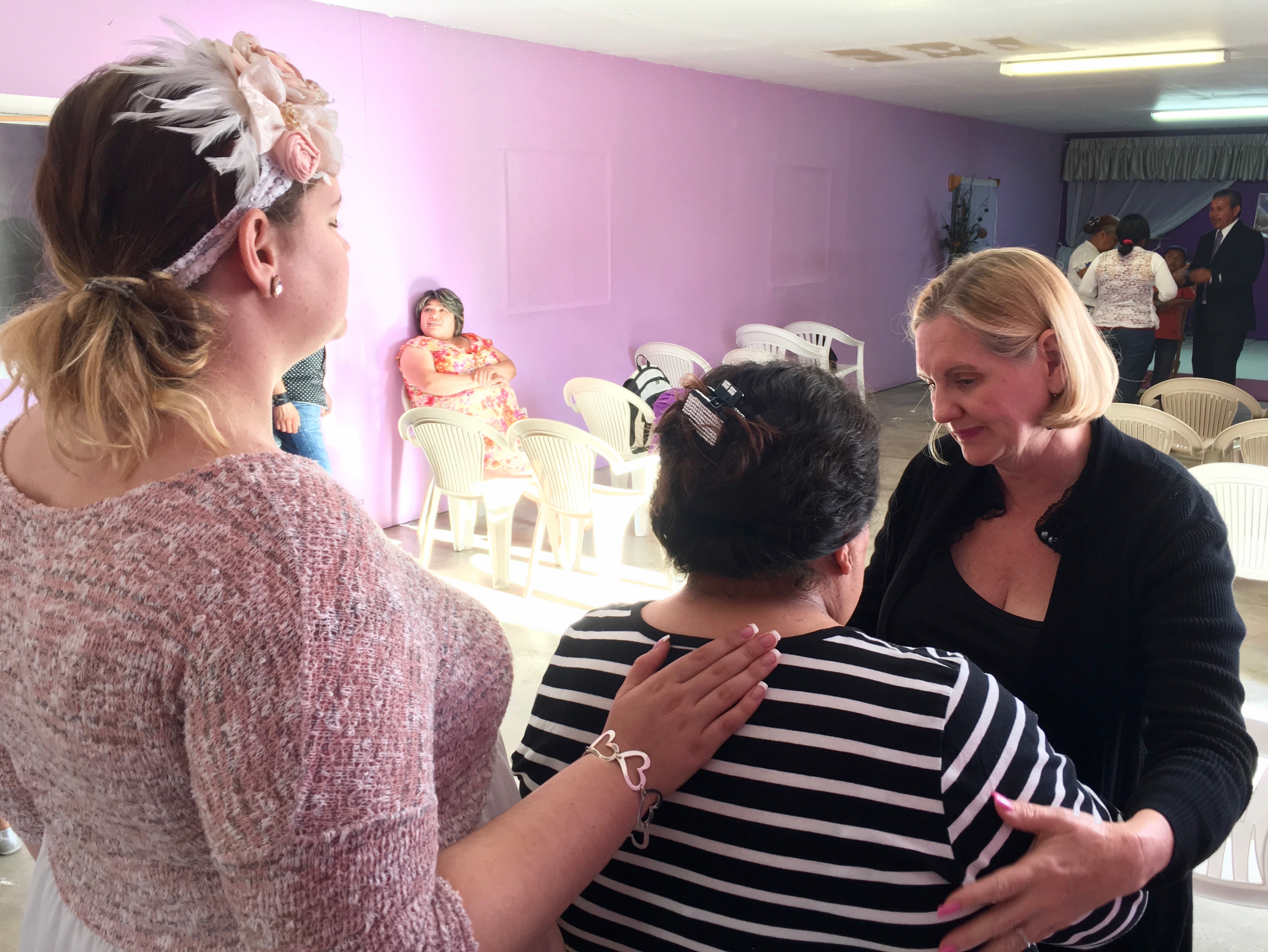 Hannah and Dawn praying for one of the women in the church