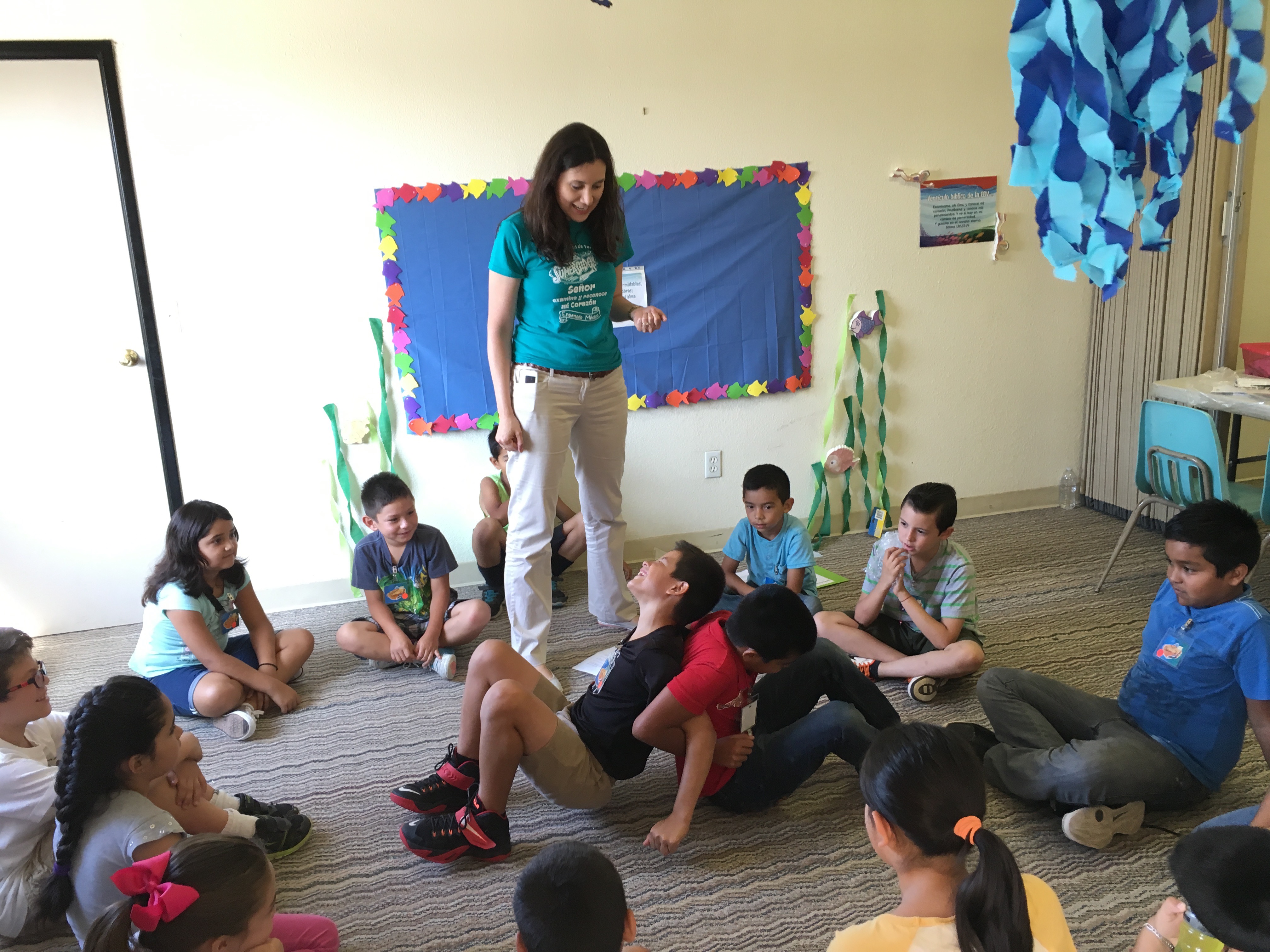 Yudy leading the children in a fun learning activity