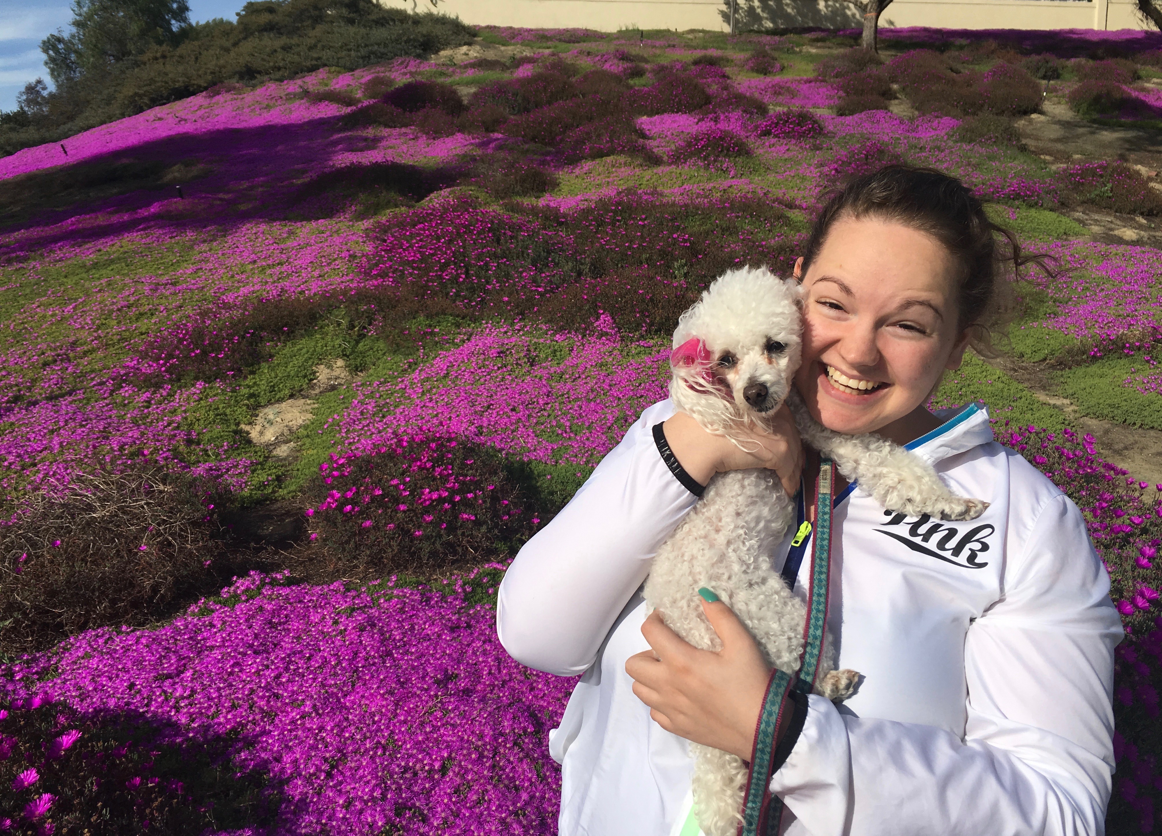 Hannah with Daisy near the flowers that bloom this time of year