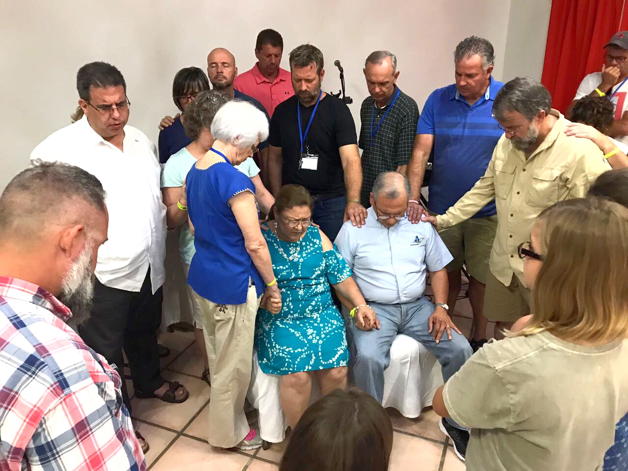 Coming together to pray for one another - Praying for Pastor Rafael Rodriquez and his wife, Martha