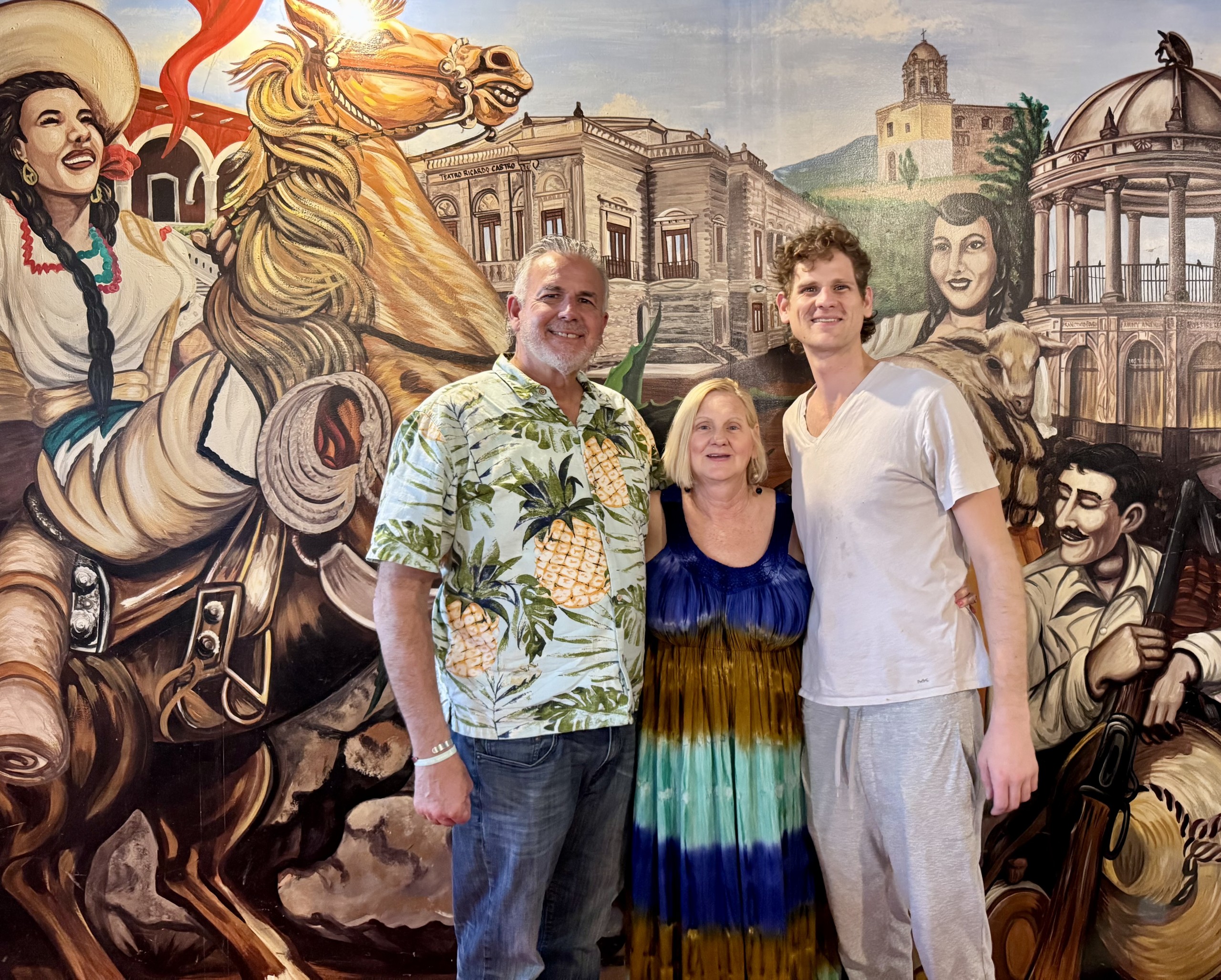 Dave, Dawn and Jonathan in front of a mural about the history of Durango.