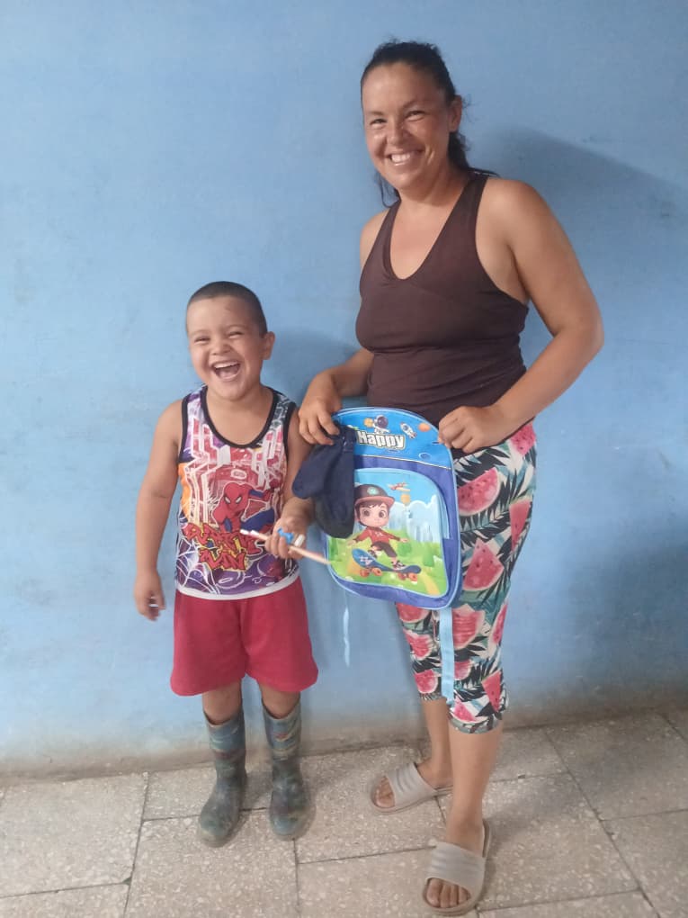 A joyful kid receiving school supplies from Hannah's Toys of Hope.