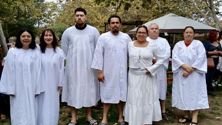 Sergio and Andrea are the couple in the middle getting baptized with the rest of their group.