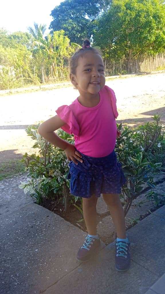 Pastor's daughter enjoying her new shoes.