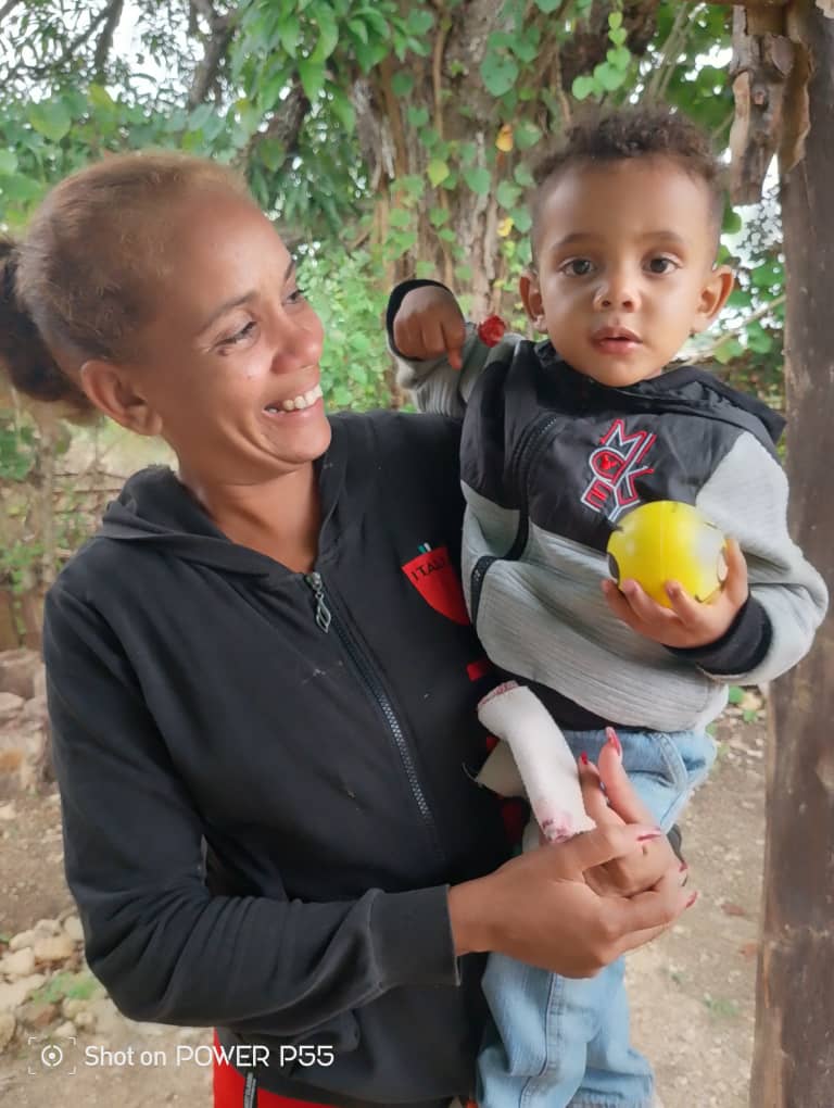 A grateful mother and her child are blessed by Hannah's Toys of Hope!