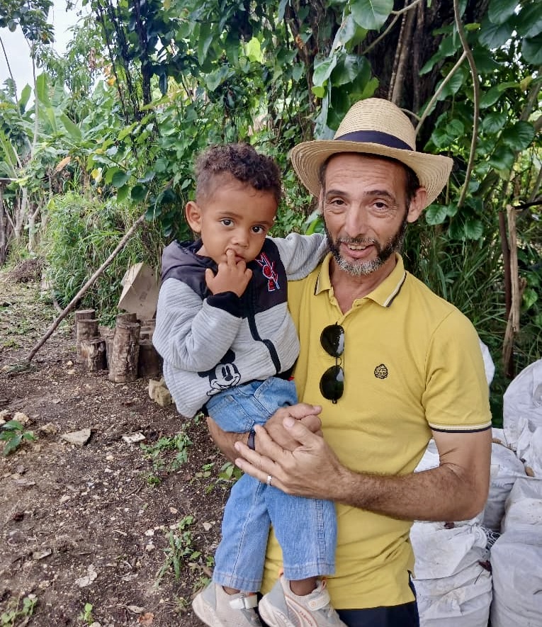 Pastor Rene holding one of the kids