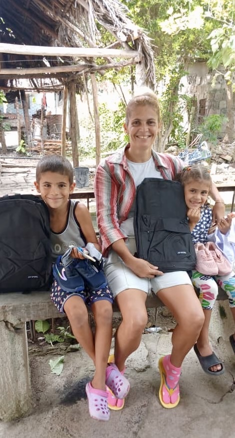 Happy family receiving back packs and shoes for school