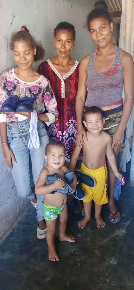 Happy faces of children receiving a blessing (shoes and socks).