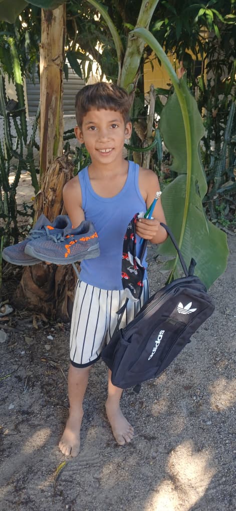 Happy face of a child receiving a new backpack for school
