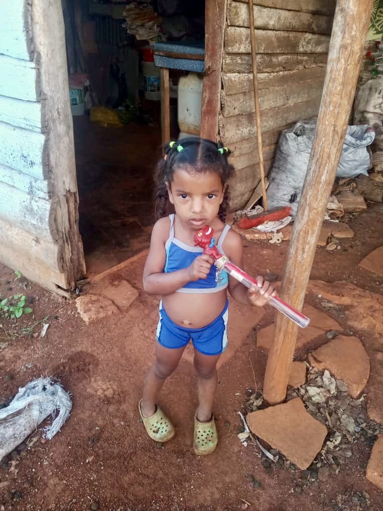 Little girl receiving a gift from our ministry