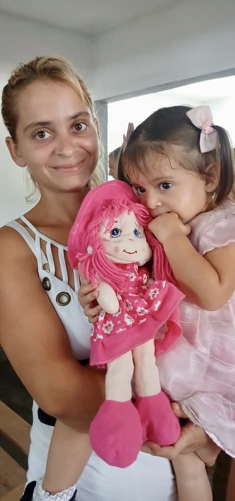 Baby girl happy to receive a doll.