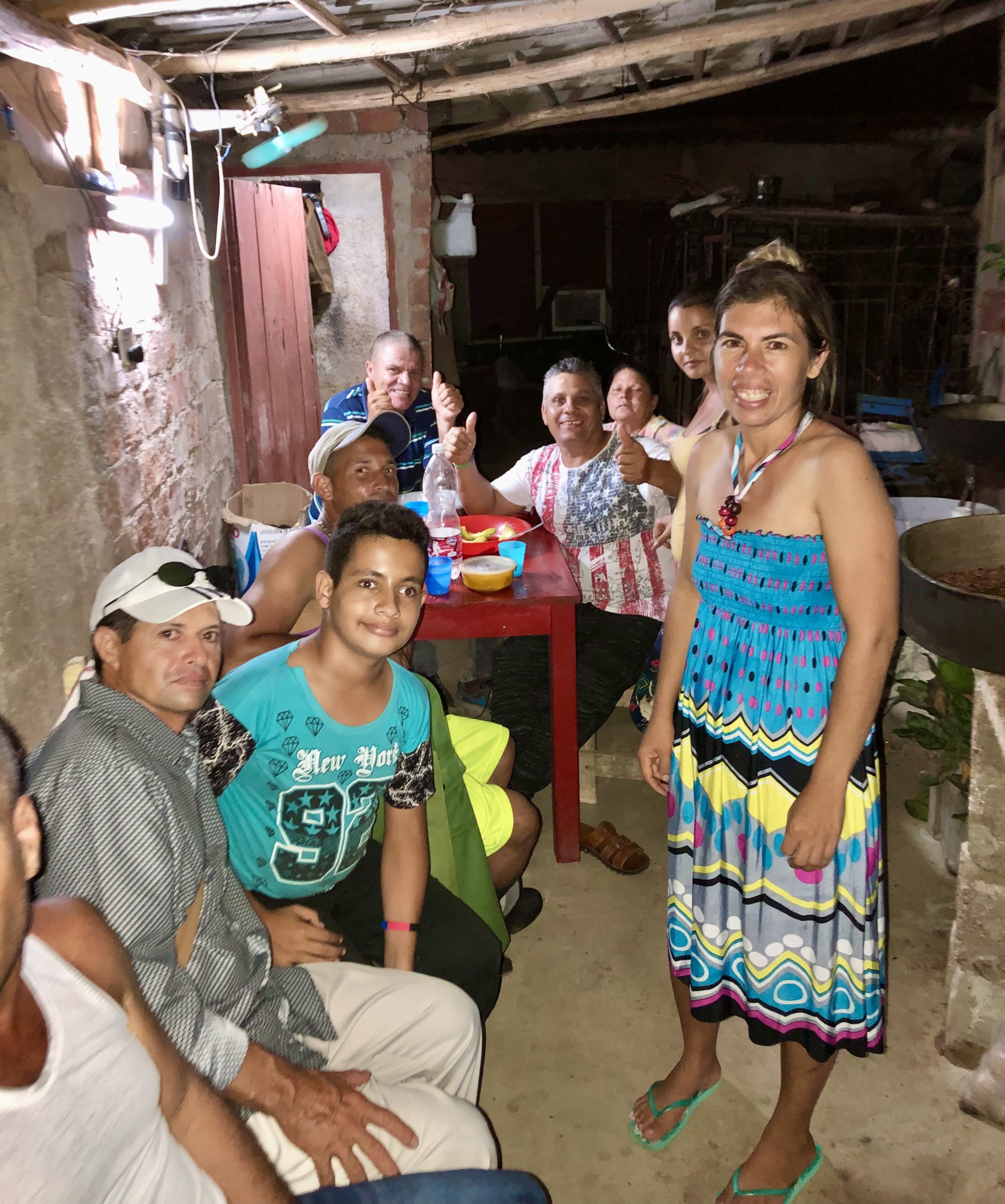 Pastor Dago (in the USA shirt) and his wife Yaima in the blue and yellow dress in their home in Cuba.