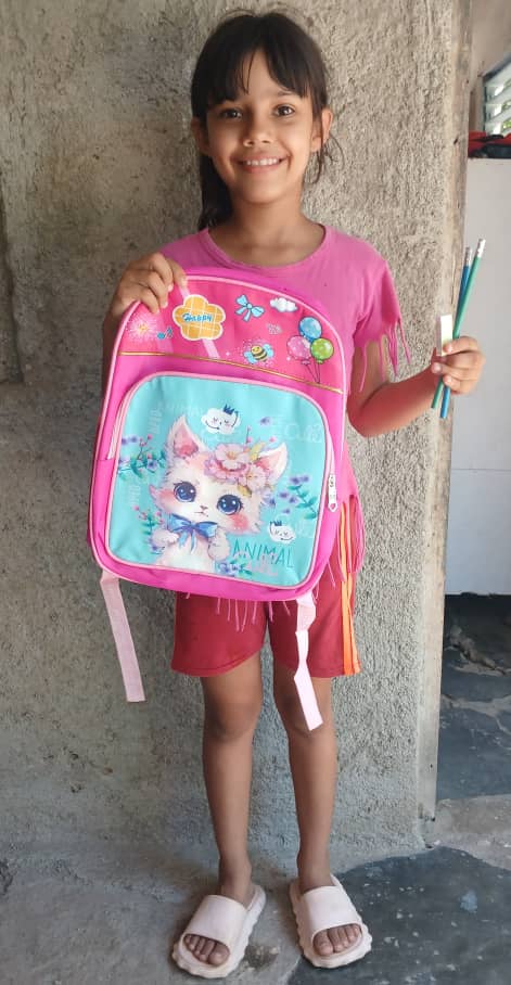 Taimaris is a pastors daughter and is very happy to receive a new backpack cause her old one had broken.