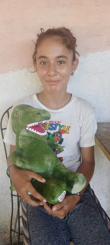 Lauren with her new stuffed Dinosaur.