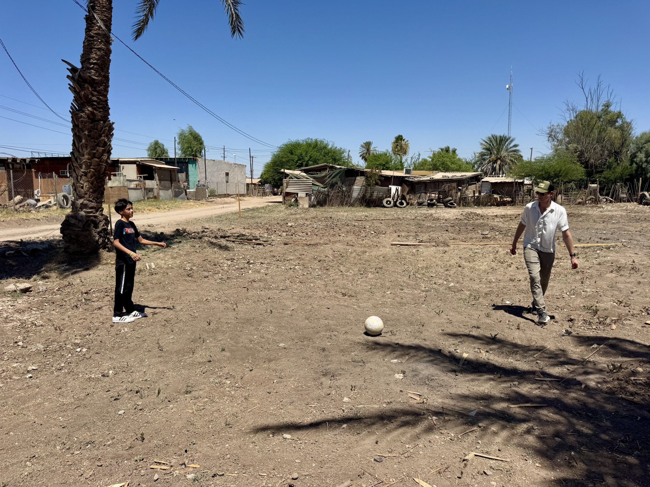 Jonathan playing soccer with Asael on the potential new field