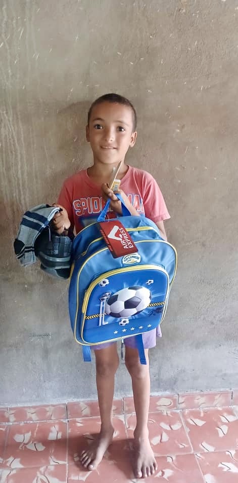 Carlos Antonio receiving backpack, shoes and socks